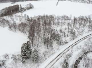 Experience the serene beauty of a winter wonderland with this stunning aerial view.