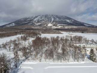 Discover this unique property nestled against a majestic snow-capped mountain, offering breathtaking winter vistas.