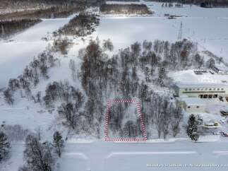 Discover this prime parcel of land nestled amidst a serene winter landscape, offering a unique opportunity for development or personal retreat.