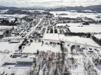 Discover this prime parcel of land nestled in a serene winter landscape, offering a unique opportunity for development or personal retreat.