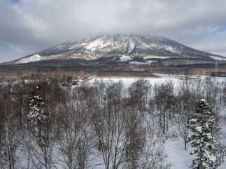 Experience the serene beauty of a winter wonderland with this stunning property nestled against a majestic snow-capped mountain.