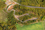 Discover this unique property featuring a winding road through lush, autumnal foliage.