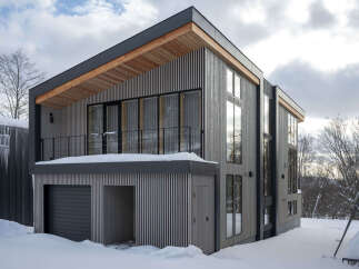 Experience modern living in this stunning architectural home, featuring a unique vertical wood siding exterior and a striking cantilevered second story.