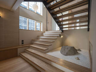 Experience tranquility in this unique home featuring a stunning zen garden with raked white gravel and natural stone accents.