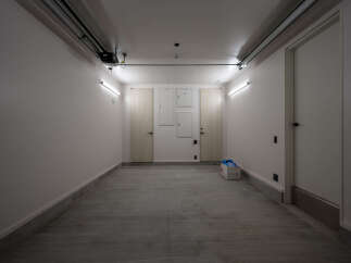 Discover this spacious and well-lit garage space, perfect for secure vehicle storage or additional storage needs.