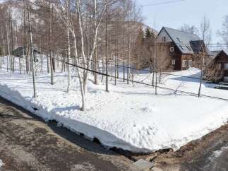 Experience the charm of a winter wonderland with this property nestled amongst snow-covered trees.