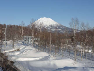 Experience the serene beauty of winter with this stunning property offering breathtaking views of a snow-capped mountain.