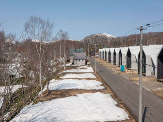Discover modern living in this picturesque setting, featuring a row of contemporary homes with striking A-frame roofs.