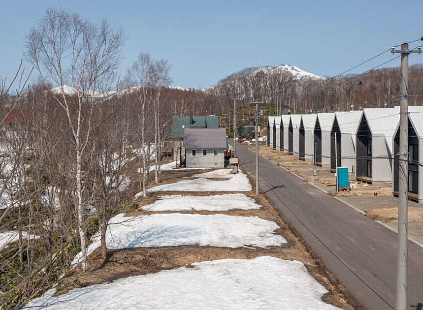 Discover modern living in this new development featuring a row of contemporary homes with distinctive A-frame roofs.