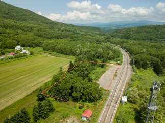 Discover this prime parcel of land nestled amidst lush greenery and rolling hills, offering a serene escape.
