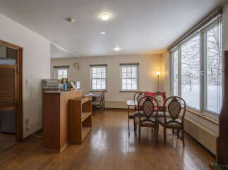 Experience cozy living in this charming space featuring a well-equipped kitchenette and a dining area perfect for intimate meals.