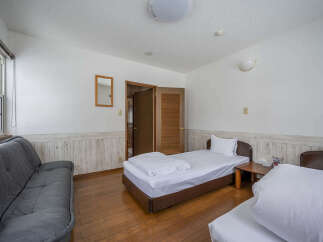 This cozy room features a comfortable sofa, perfect for relaxing after a long day.