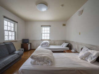 This cozy hotel room features two comfortable beds, perfect for families or groups traveling together.