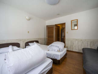 This inviting bedroom features two comfortable beds, perfect for accommodating guests or family.