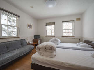 This cozy room features two comfortable beds, perfect for a relaxing stay.