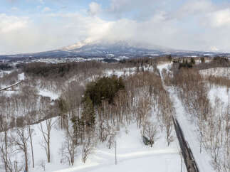 Experience the serene beauty of a winter wonderland with this stunning aerial view.