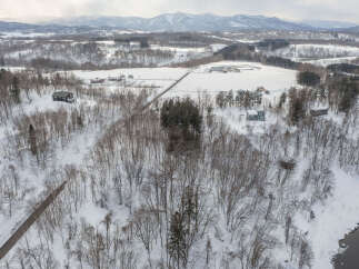 Discover this charming winter retreat nestled amidst snow-covered trees and rolling hills.