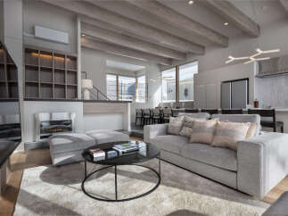 Experience modern luxury in this spacious living area, featuring a sleek fireplace, comfortable sectional sofa, and a stylish coffee table.