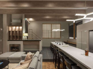 Experience modern luxury in this spacious open-plan living area, featuring a sleek kitchen island perfect for entertaining and a cozy fireplace for intimate gatherings.
