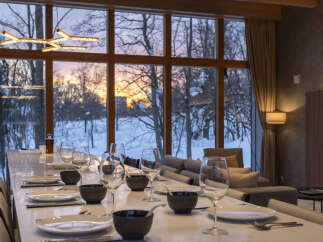 Experience luxurious dining with a breathtaking sunset view in this elegant dining room.