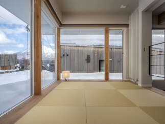 Experience breathtaking winter views from this modern home, featuring expansive floor-to-ceiling windows that showcase snow-covered landscapes and majestic mountains.