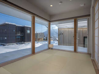 Experience breathtaking winter views from this modern home featuring expansive floor-to-ceiling windows.