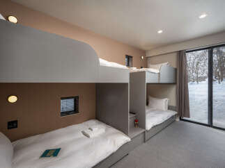 Experience cozy comfort in this spacious room featuring multiple bunk beds, perfect for families or groups.