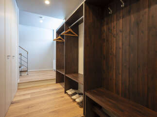 Discover this inviting entryway featuring a spacious built-in closet with ample hanging space and convenient shelving.