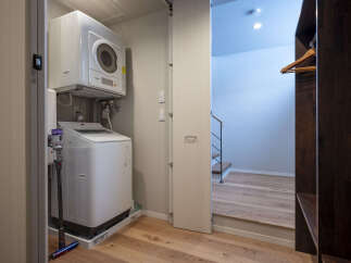 Discover modern convenience with a stacked washer and dryer unit, perfect for maximizing space in this home.