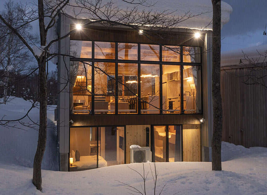 Experience modern living in this stunning architectural home nestled in a serene, snowy landscape.