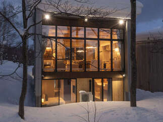 Experience modern living in this stunning architectural home nestled in a serene, snowy landscape.