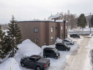 Discover this charming property nestled in a serene, snow-covered landscape, perfect for a winter retreat.
