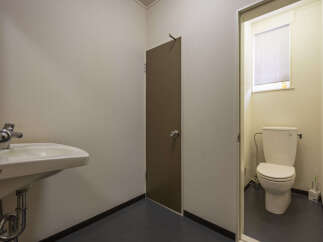 This property features a clean and functional bathroom area with a modern sink and a separate toilet room.