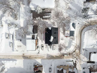 Experience the charm of winter living in this picturesque neighborhood, blanketed in fresh snow.