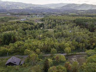 Discover this charming property nestled amidst a vibrant autumn forest, offering a serene retreat.