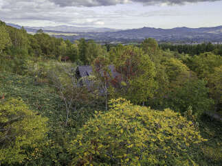Nestled amidst a vibrant autumn landscape, this property offers a serene retreat with stunning panoramic views.