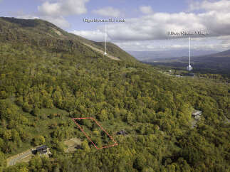 Discover this stunning property nestled amidst the vibrant autumn foliage, offering breathtaking views of the surrounding mountains.