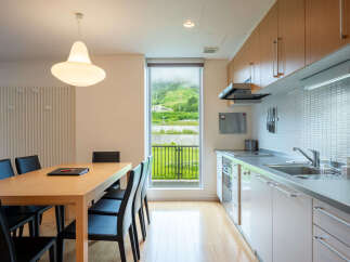 Enjoy a spacious dining area adjacent to a modern, well-equipped kitchen, perfect for entertaining.