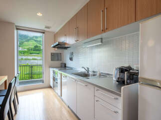 Experience modern living in this beautifully appointed kitchen, featuring sleek cabinetry and a spacious stainless steel countertop.