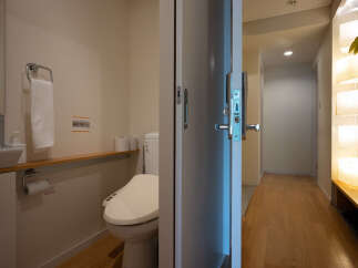 Step into a modern and clean bathroom featuring a sleek toilet and a convenient towel rack.