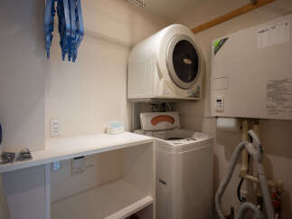 This laundry room features a stacked washer and dryer unit, perfect for maximizing space.