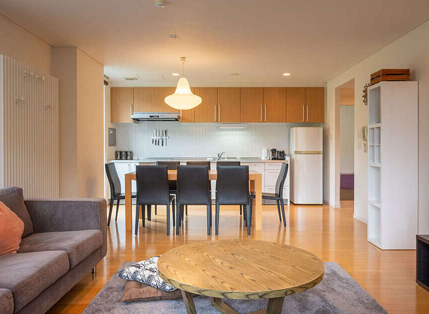 Experience modern living in this open-concept apartment, featuring a sleek kitchen with ample cabinet space and a dining area perfect for entertaining.