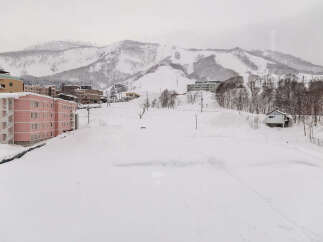Experience the charm of a winter wonderland with this property nestled in a snowy mountain landscape.