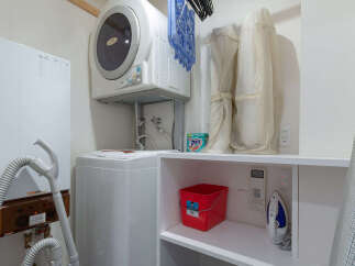 Discover a functional laundry space designed for modern living, featuring a stacked washer and dryer for space efficiency.