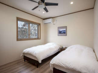 This charming bedroom features two comfortable twin beds, perfect for accommodating guests or family.
