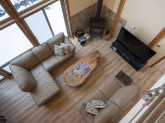 Experience luxury living in this spacious living room, featuring a sectional sofa and a cozy fireplace.