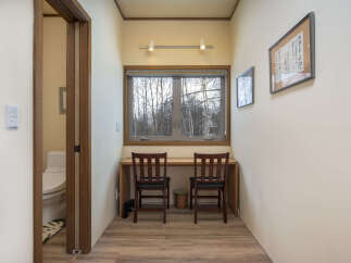 This cozy nook features a built-in desk with two chairs, perfect for a home office or study area.
