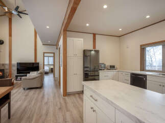 Experience modern living in this open-concept home featuring a spacious kitchen with a large island and sleek cabinetry.