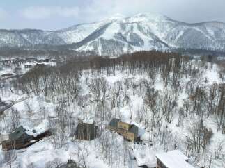 Experience the ultimate winter getaway in this stunning ski resort property, nestled amidst snow-covered trees and majestic mountains.