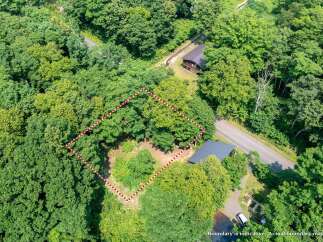 Discover this secluded wooded lot, perfect for building your dream home amidst nature's tranquility.